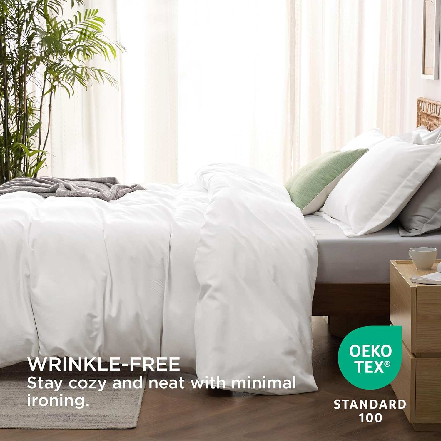 Wrinkle-free white bedding set on a neatly made bed with green pillows, promoting comfort and minimal ironing, Oeko-Tex Standard 100 certified.