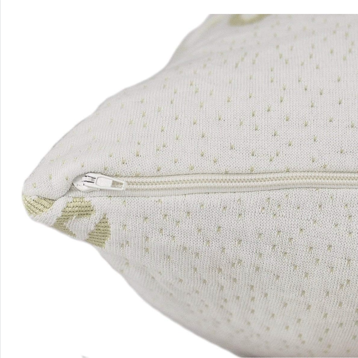 Close-up of an elegant white textured cushion with a smooth zipper.