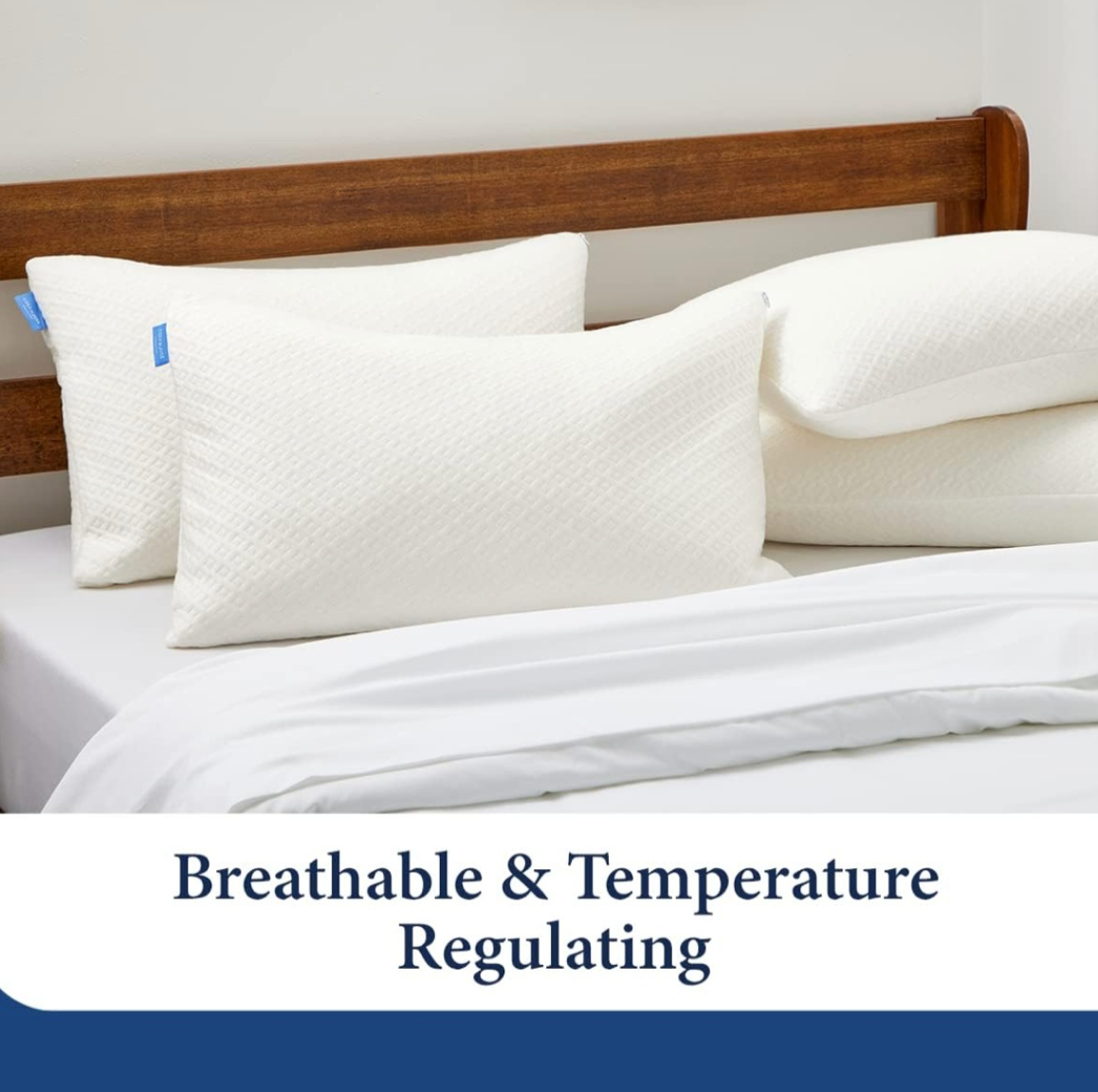 Breathable and temperature-regulating white pillows on a wooden bed with white bedding.