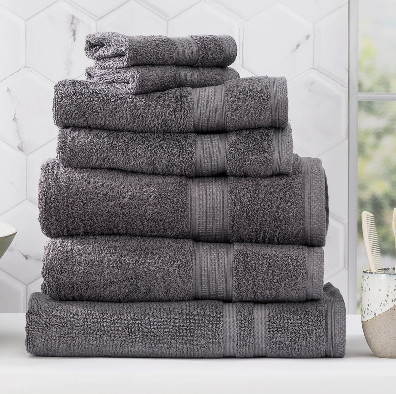 Stack of luxurious grey towels in a modern bathroom setting