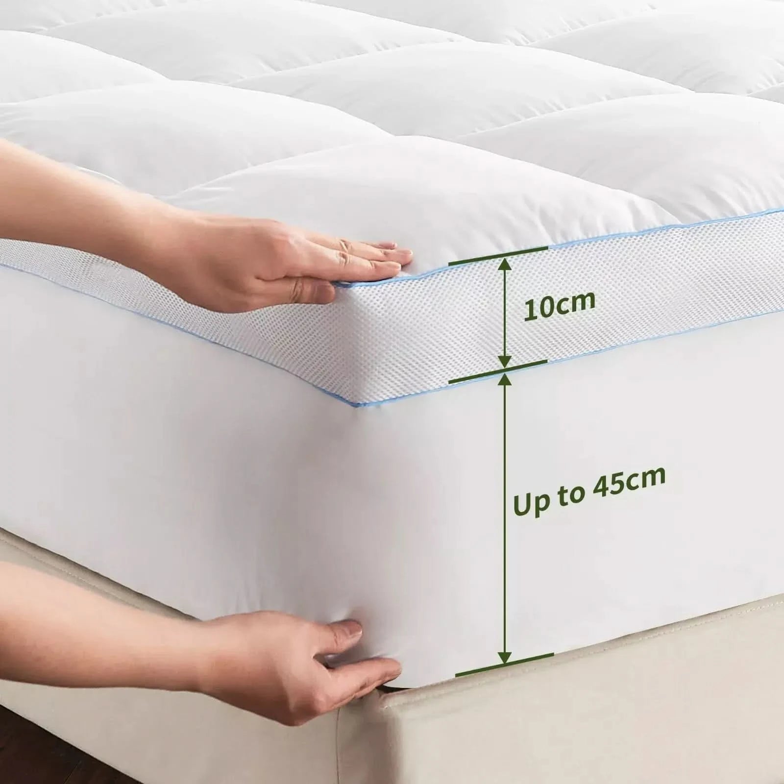 Hands adjusting a white quilted mattress topper with deep elasticized pockets, ensuring a secure and snug fit on a thick mattress.