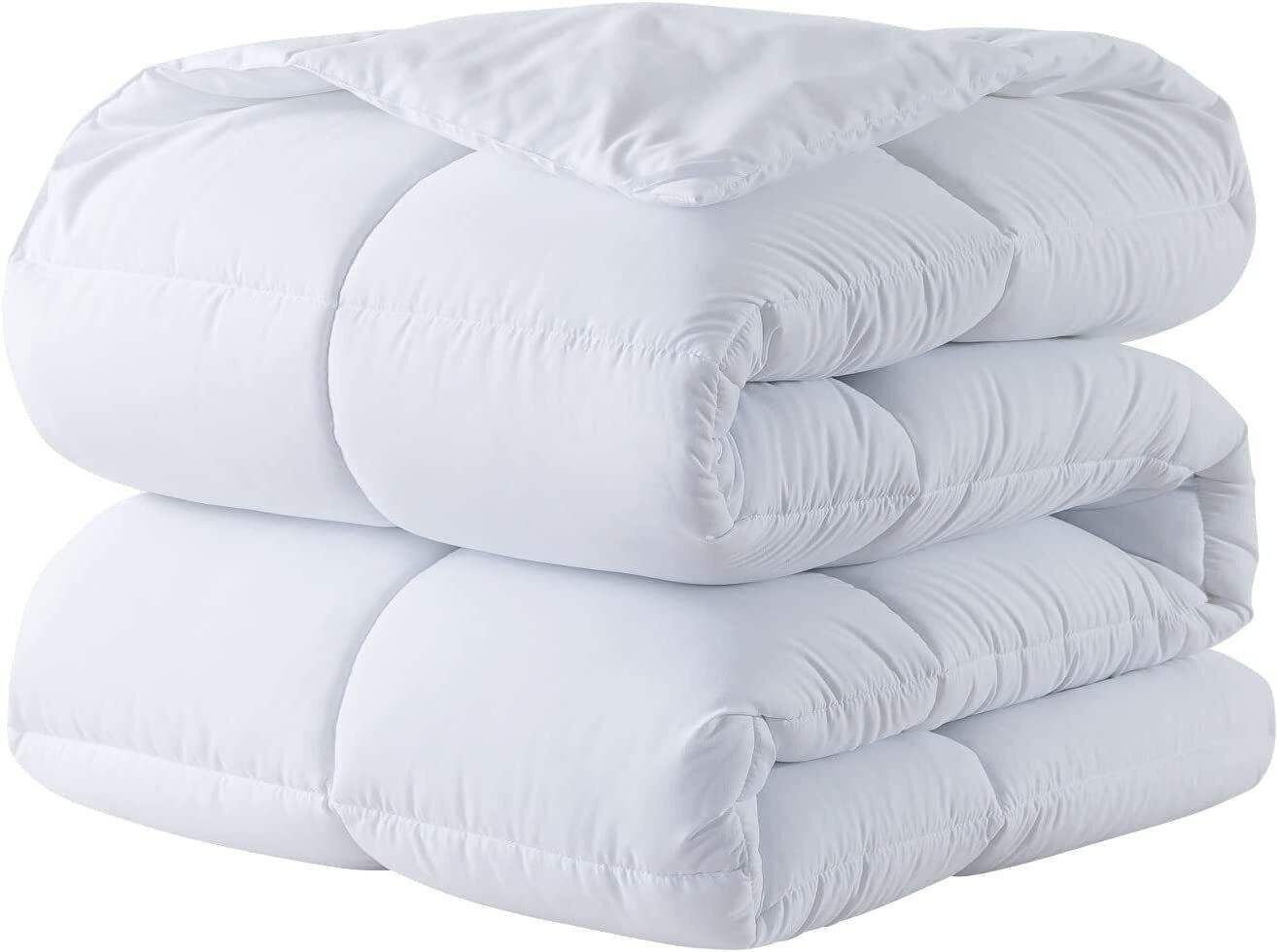 Soft and fluffy white comforter neatly folded on a white background.